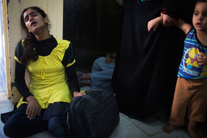 A Palestinian girl who fled what medics said was Israeli shelling that hit a U.N-run school sheltering Palestinian refugees, sits in shock at a hospital in Beit Hanoun in the northern Gaza Strip July 24, 2014.(Reuters / Finbarr O'Reilly)