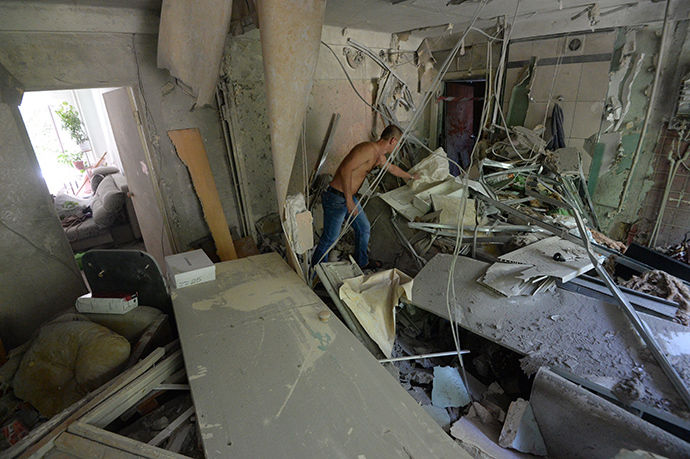 A dweller of an apartment building damaged during an artillery attack by the Ukrainian Security Forces in Donetsk suburb, inside his destroyed apartment. (RIA Novosti / Mikhail Voskresenskiy)