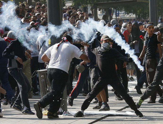 Protesters throw projectiles in Place de la Republique during a banned demonstration in support of Gaza in central Paris, July 26, 2014. (Reuters/Benoit Tessier)