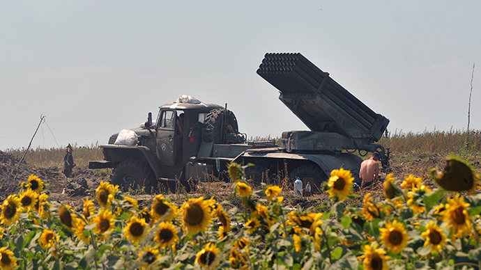 A Ukrainian serviceman rests near a multiple rocket launcher "Grad" set on the position near the eastern city of Seversk on July 12, 2014 (AFP Photo / Genya Savilov)