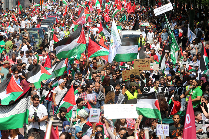 People wave Palestinian flags during a demonstration against Israel's military operation in Gaza in Brussels on July 27, 2014 (AFP Photo / Nicolas Maeterlinck)