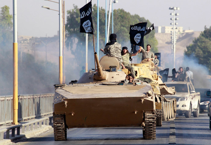 Militant Islamist fighters take part in a military parade along the streets of the northern Raqqa province (Reuters)