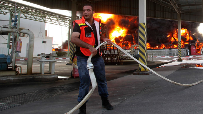 A Palestinian firefighter tries to put out a fire at Gaza's main power plant, which witnesses said was hit in Israeli shelling, in the central Gaza Strip July 29, 2014. (Reuters / Ahmed Zakot)