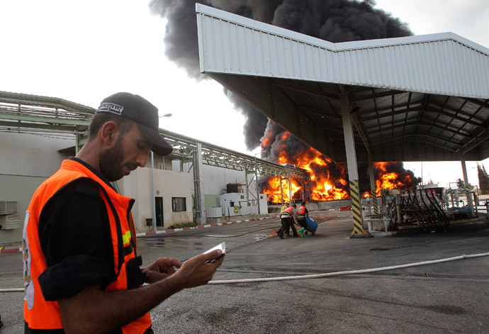 Palestinian firefighters participate in efforts to put out a fire at Gaza's main power plant, which witnesses said was hit in Israeli shelling, in the central Gaza Strip July 29, 2014. (Reuters / Ahmed Zakot)