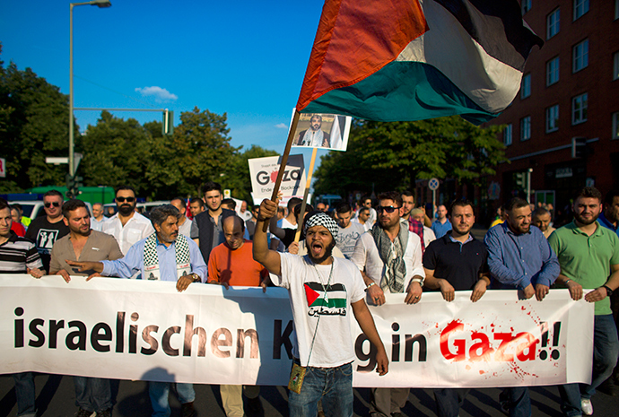 People hold a banner during a protest in central Berlin denouncing Israeli military actions in Gaza July 26, 2014 (Reuters / Thomas Peter)