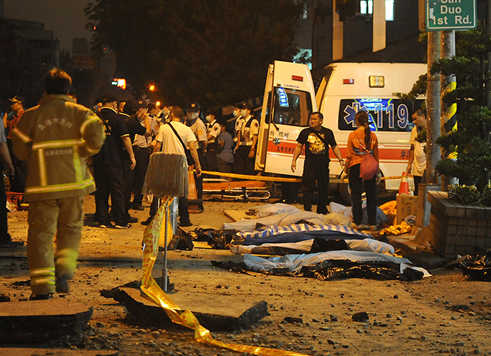 Bodies are seen covered after an explosion in Kaohsiung, southern Taiwan, August 1, 2014. (Reuters / Stringer)