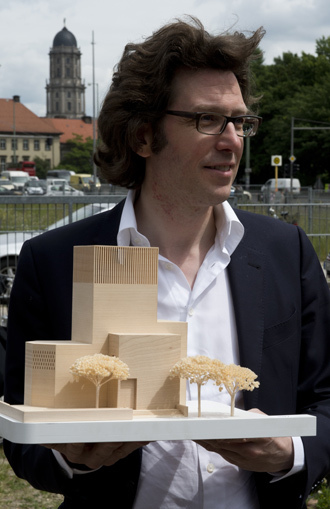 German architect Wilfried Kuehn holds a model of his design for the House of Prayer and Learning project, a multifaith prayer building, in Berlin (AFP Photo / John Macdougall)