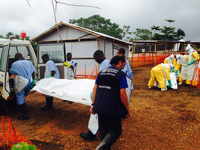 Volunteers carry bodies in a centre run by Medecins Sans Frontieres for Ebola patients in Kailahun July 18, 2014 (Reuters / Tarik Jasarevic)