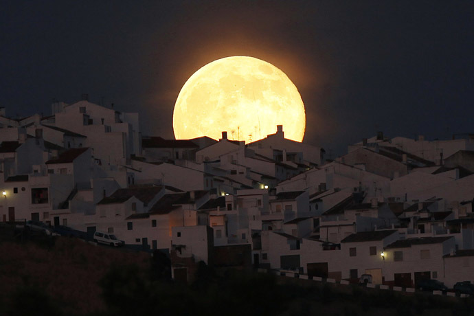 The Supermoon rises over houses in Olvera, in the southern Spanish province of Cadiz, July 12, 2014. (Reuters/Jon Nazca)