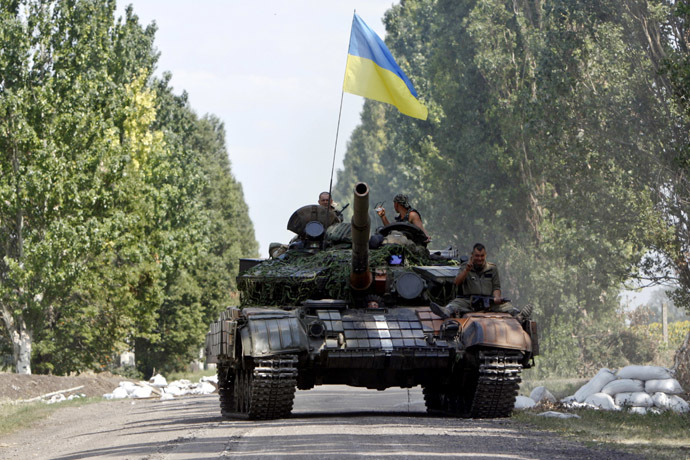 Ukrainian tanks move along a road near Eastern Ukrainian village of Novoselivka Persha July 31, 2014. (Reuters/Valentyn Ogirenko)