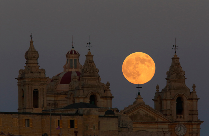 The supermoon rises behind the cathedral in Mdina, Malta's ancient capital city, in the centre of the island, August 10, 2014 (Reuters / Darrin Zammit Lupi)