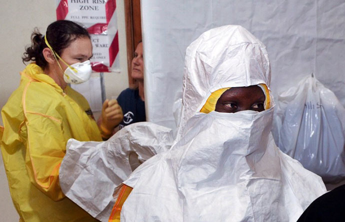 A picture taken on July 24, 2014 shows staff of the Christian charity Samaritan's Purse putting on protective gear in the ELWA hospital in the Liberian capital Monrovia. (AFP Photo / Zoom Dosso)