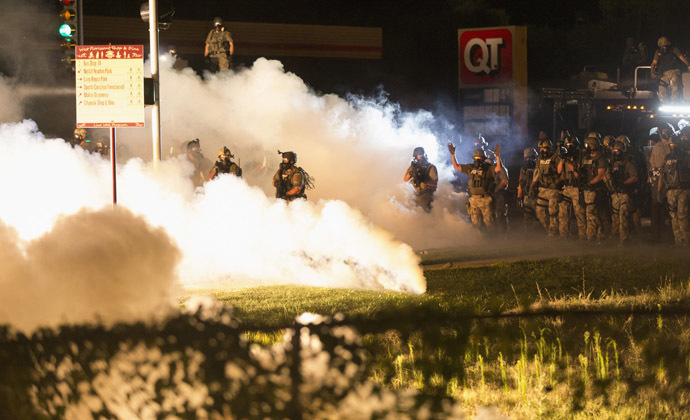 Riot police clear a street with smoke bombs while clashing with demonstrators in Ferguson, Missouri August 13, 2014. (Reuters)