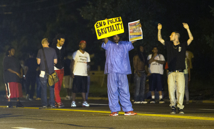 Demonstrators stand in the street in Ferguson, Missouri August 11, 2014. (Reuters / Mario Anzuoni) 