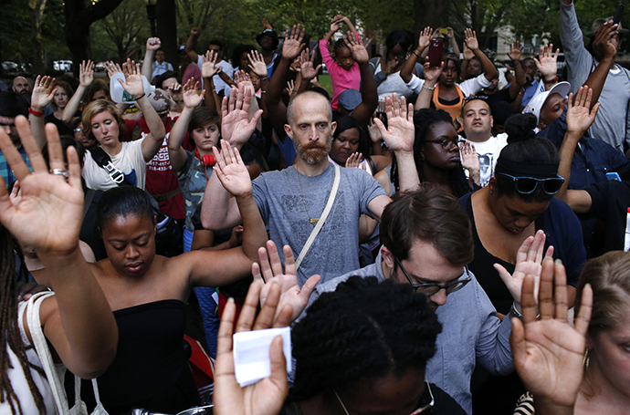 People put their hands up as a symbol to honor Michael Brown, who was shot and killed by an unnamed police officer last Saturday in Ferguson, Missouri, at the borough of Brooklyn in New York August 14, 2014. (Reuters / Eduardo Munoz)