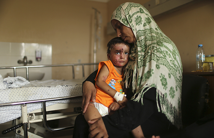 Palestinian boy Mohammed Wahdan, whom medics said was wounded in Israeli shelling, is held by his aunt as he receives psychological care at Shifa hospital in Gaza City August 14, 2014. (Reuters / Mohammed Salem)