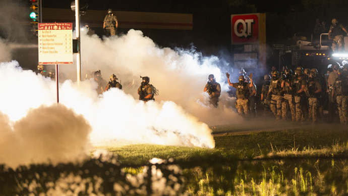 Riot police clear a street with smoke bombs while clashing with demonstrators in Ferguson, Missouri August 13, 2014. (Reuters / Mario Anzuoni)