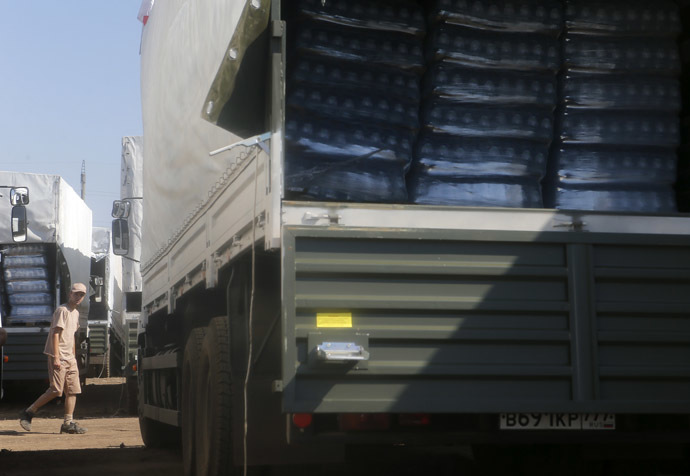 A driver walks past Russian convoy of trucks carrying humanitarian aid for Ukraine at a camp near Kamensk-Shakhtinsky, Rostov Region, August 15, 2014. (Reuters/Maxim Shemetov)
