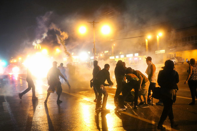 Police fire tear gas at demonstrators protesting the shooting of Michael Brown after they refused to honor the midnight curfew on August 17, 2014 in Ferguson, Missouri. (Scott Olson/Getty Images/AFP)