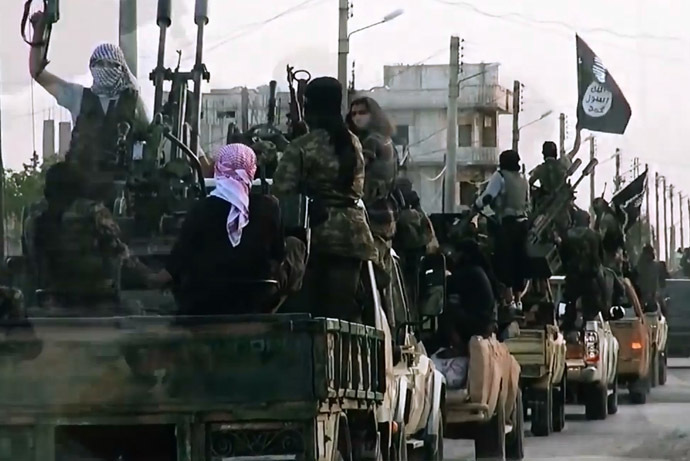 An image grab taken from a propaganda video released on March 17, 2014 by the Islamic State of Iraq and the Levant (ISIL)'s al-Furqan Media allegedly shows ISIL fighters driving on a street in the northern Syrian City of Homs. (AFP Photo)