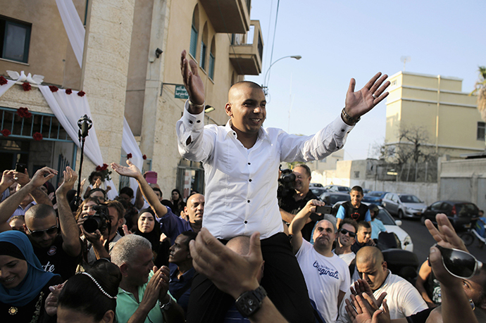 Groom Mahmoud Mansour, 26, celebrates with friends and family before his wedding to bride Maral Malka, 23, (not pictured) in Jaffa, south of Tel Aviv August 17, 2014. (Reuters / Ammar Awad)