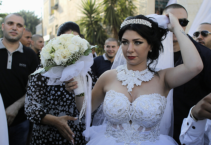 Bride Maral Malka, 23, celebrates with friends and family before her wedding to groom Mahmoud Mansour, 26, (not pictured) in Jaffa, south of Tel Aviv August 17, 2014. (Reuters / Ammar Awad)