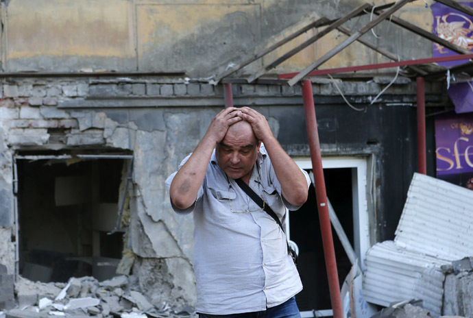 A man reacts as he stands in front of a building damaged by, what locals say, was recent shelling by Ukrainian forces, in Donetsk, August 20, 2014. (Reuters/Maxim Shemetov)