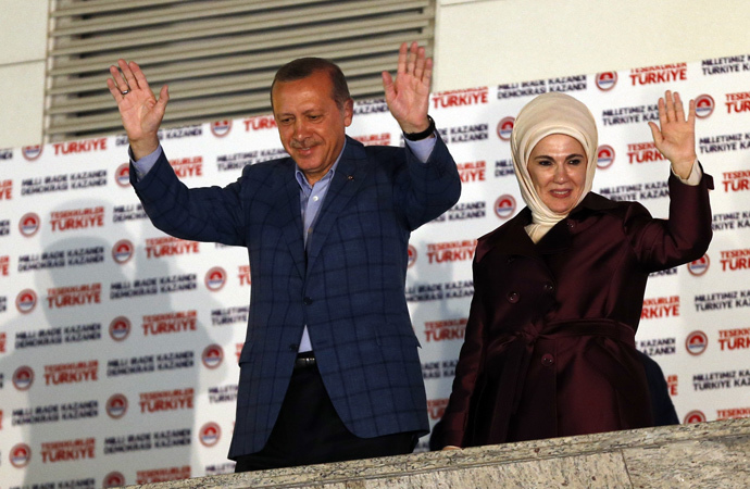 Turkey's Prime Minister Tayyip Erdogan and wife Ermine wave hands to supporters as they celebrate his election victory in front of the party headquarters in Ankara August 10, 2014. (Reuters / Umit Bektas)