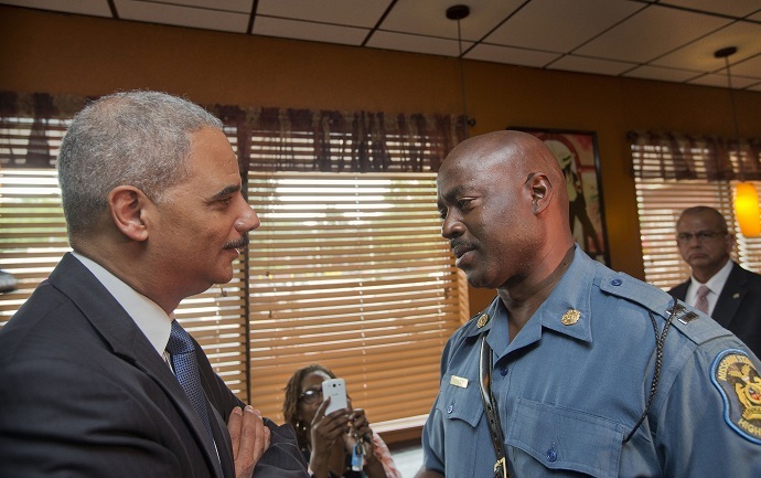 Attorney General Eric Holder talks with Capt. Ron Johnson of the Missouri State Highway Patrol at Drake's Place Restaurant in Florrissant, Missouri August 20, 2014. (Reuters/Pablo Martinez Monsivais/Pool)