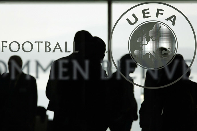 Silhouettes are seen inside the UEFA Headquarters in Nyon. (AFP Photo/Fabrice Coffrini)
