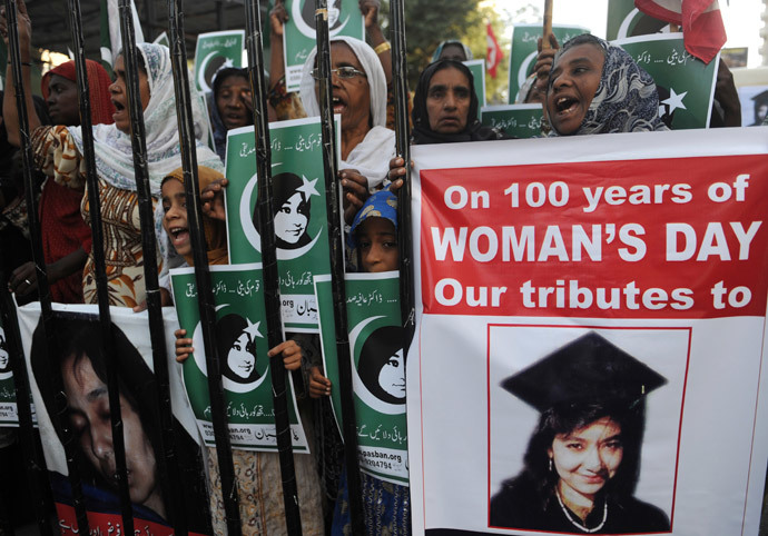Pakistani protestors from the hard line Sunni group, Pasban, hold portraits of Pakistani scientist Aafia Siddiqui during a demonstration marking International Women's Day.(AFP Photo / Rizwan Tabassum)