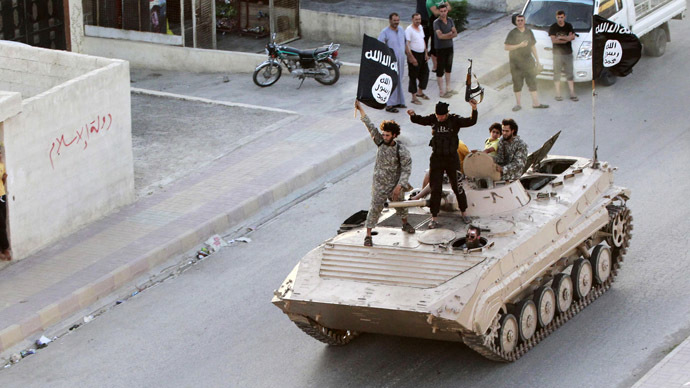 Militant Islamist fighters take part in a military parade along the streets of northern Raqqa province June 30, 2014 (Reuters)