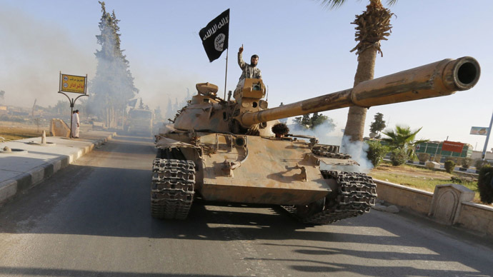 Militant Islamist fighters on a tank take part in a military parade along the streets of northern Raqqa province June 30, 2014. (Reuters)