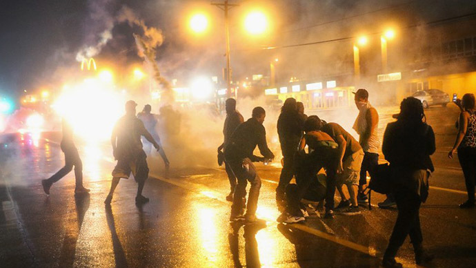 Police fire tear gas at demonstrators protesting the shooting of Michael Brown after they refused to honor the midnight curfew on August 17, 2014 in Ferguson, Missouri. (AFP Photo / Getty Images / Scott Olson)
