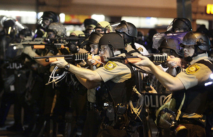 Police officers point their weapons at demonstrators protesting against the shooting death of Michael Brown in Ferguson, Missouri August 18, 2014. (Reuters / Joshua Lott)