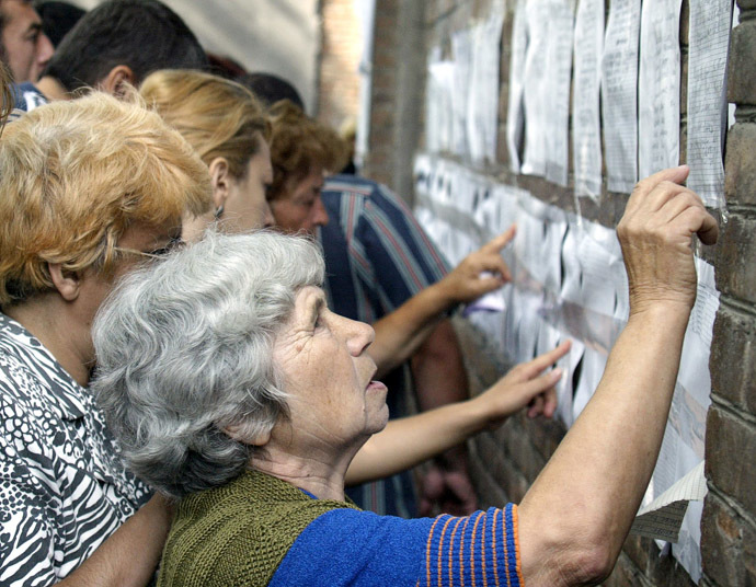 Relatives of terrorist act victims check the lists of injured at the hospital in the town of Beslan, North Ossetia, 04 September 2004, after Russian security forces gained control of the school where up to 1000 children and adults had been held hostage by armed rebels. (AFP Photo)