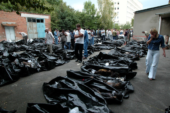 People search for relatives among the bodies of dead hostages at a morgue in the town of Vladikavkaz, September 4, 2004. (Reuters/Sergei Karpukhin)
