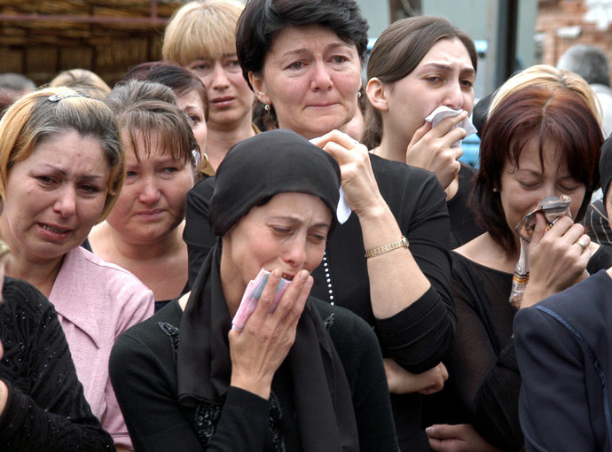 Relatives and neighbours of killed sisters hostages Irina,13 and Alina,12 Tetova cry during their funeral in the town of Beslan in the province of North Ossetia near Chechnya, September 5, 2004. (Reuters)