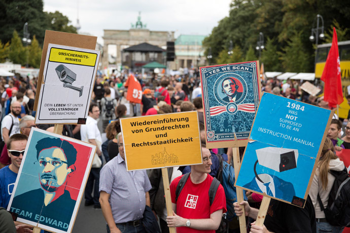 Participants hold placards reading (L to R) "Team Edward", "reintroduction of basic rights", "yes we scan" and "1984 was not supposed to be an instruction manual" during a demonstration against governmental surveillance on August 30, 2014 in Berlin. (AFP/DPA)