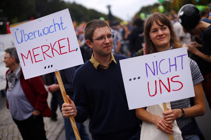 People hold placards during a "Freiheit Statt Angst" (Freedom instead of Fear) protest calling for the protection of digital data privacy and the reigning in of digital surveillance practices, in Berlin August 30, 2014. The placards read, "Put Merkel under surveillance...", "...Not us." (Reuters/Thomas Peter)