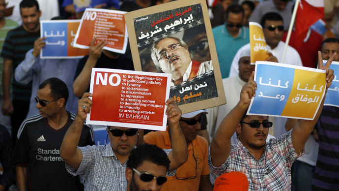 Protesters holding anti-government banners participate in a rally organised by Bahrain's main opposition party Al Wefaq in Budaiya August 8, 2014. (Reuters/Hamad I Mohammed)
