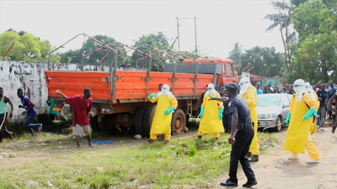 Health workers surround an Ebola patient who escaped from quarantine from Monrovia's Elwa hospital, in the centre of Paynesville in this still image taken from a September 1, 2014 video. (Reuters/Reuters TV)