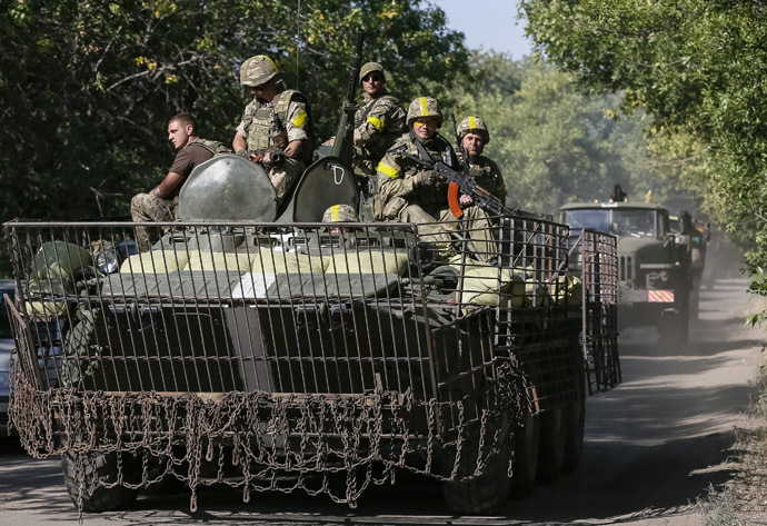 Ukrainian servicemen ride in an armoured vehicle near Kramatorsk September 2, 2014. (Reuters/Gleb Garanich)