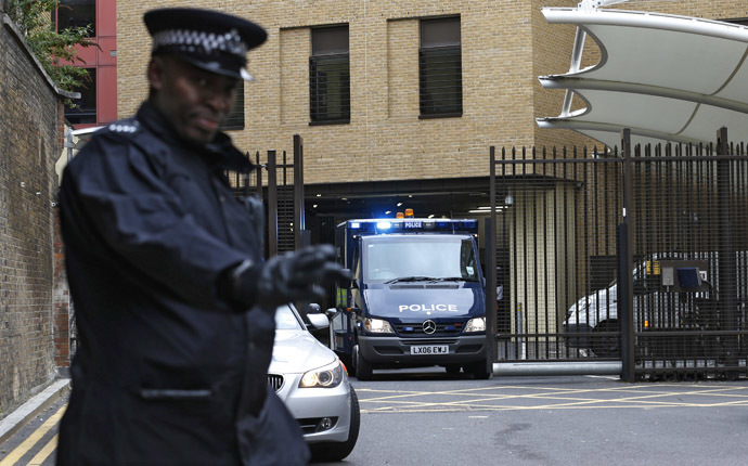 A police officer guards the rear entrance of Westminster Magistrates Court as the van carrying bombing suspect John Downey leaves, in London May 22, 2013. (Reuters/Suzanne Plunkett)