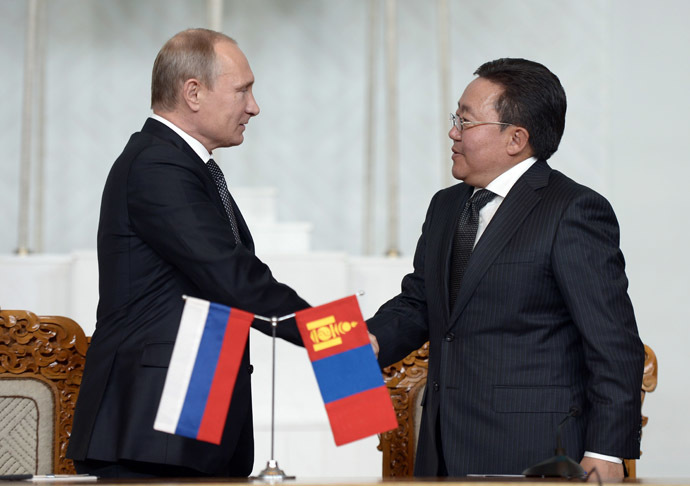 Russian President Vladimir Putin, left, and his Mongolian counterpart Tsakhiagiin Elbegdorj sign joint agreements following Russian-Mongolian talks at State Palace in Ulan-Bator. (RIA Novosti/Aleksey Nikolskyi)