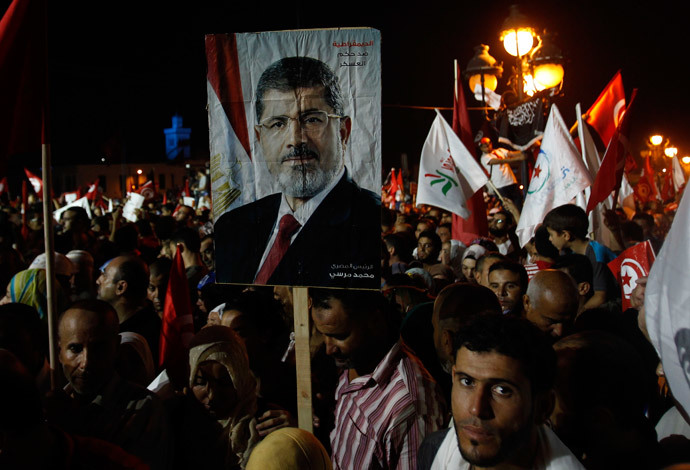 Supporters of the Islamist Ennahda movement hold a portrait of ousted Mohamed Morsi during a demonstration at Kasbah Square in Tunis August 3, 2013.(Reuters / Zoubeir Souissi)