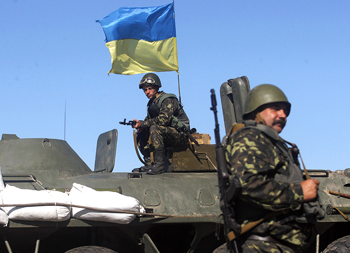 A Ukrainian serviceman sit ontop of an armoured personnel carrier during a patrol on the border of the Donetsk and Luhansk regions near town of Debaltseve, on September 5, 2014. (AFP Photo / Anatoliy Stepanov)