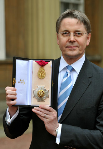 Jeremy Heywood, permanent secretary at No 10 and Cabinet Secretary, poses with his medal after was made a Knight Commander of the Order of the Bath by the Prince of Wales at Buckingham Palace during an investiture ceremony on May 4, 2012. (AFP Photo/John Stillwell