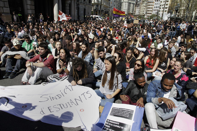 Students chant during a demonstration on the second day of a 48-hour nationwide student strike to protest against rising fees, educational cuts and the LOMCE (the new education law) in Valencia, March 27, 2014. (Reuters/Heino Kalis)