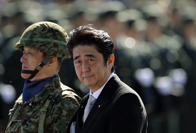 Japanese Prime Minister Shinzo Abe (R) reviews Japanese Self-Defence Forces' (SDF) troops during the annual SDF ceremony at Asaka Base in Asaka, near Tokyo, in this October 27, 2013 file photo. (Reuters//Issei Kato/Files)